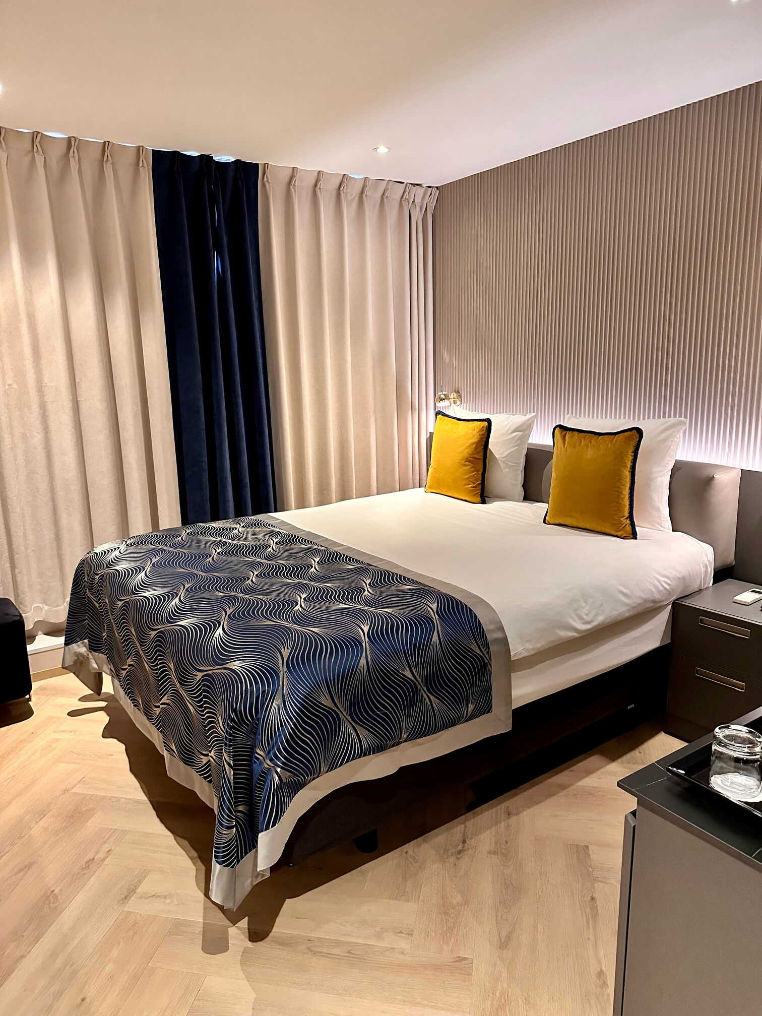 Elegantly designed hotel room with warm lighting and plush textures