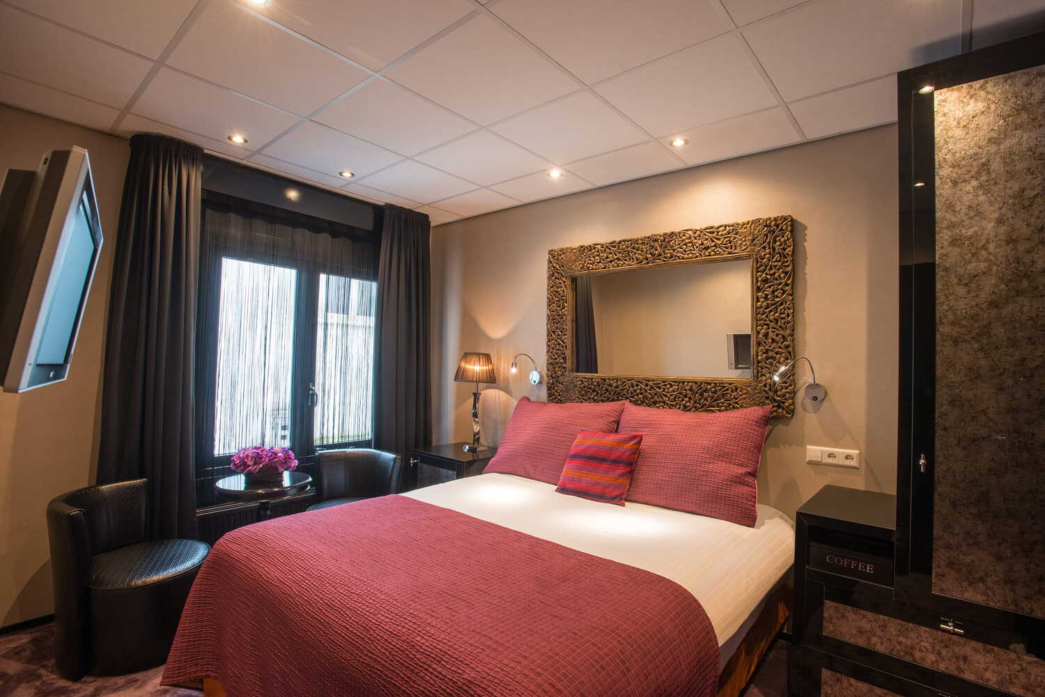 Elegant small double room with plush bedding and warm ambient lighting at Hotel Sebastian's